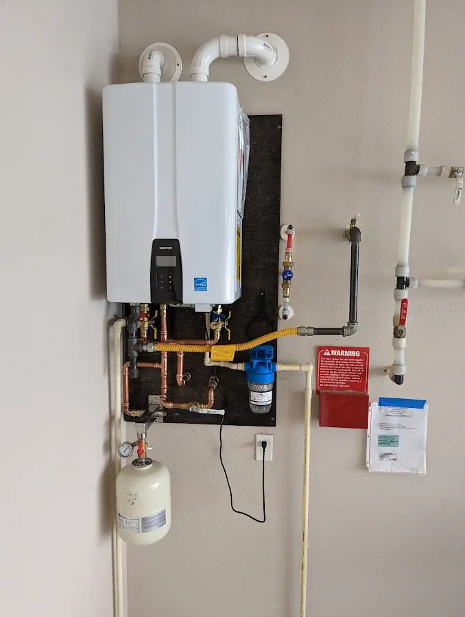 Professional plumber installing copper piping in a Smithfield home